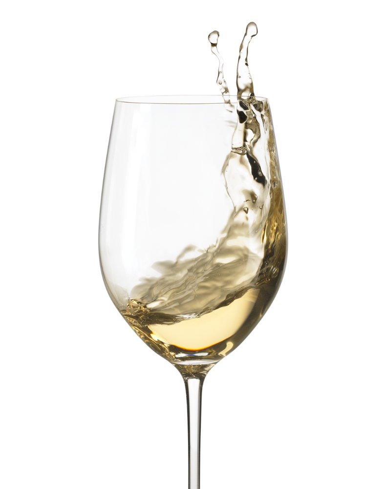 Action shot of white wine swirled in wine glass – Photograph by George Ong
