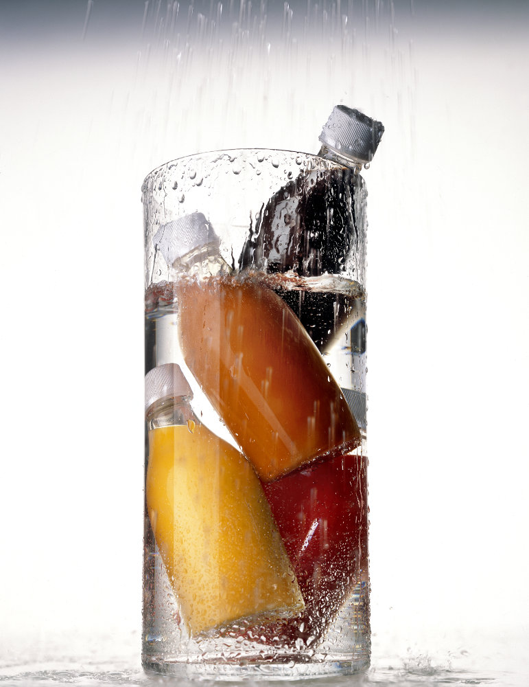 Red beauty bottles under water – Photograph by George Ong