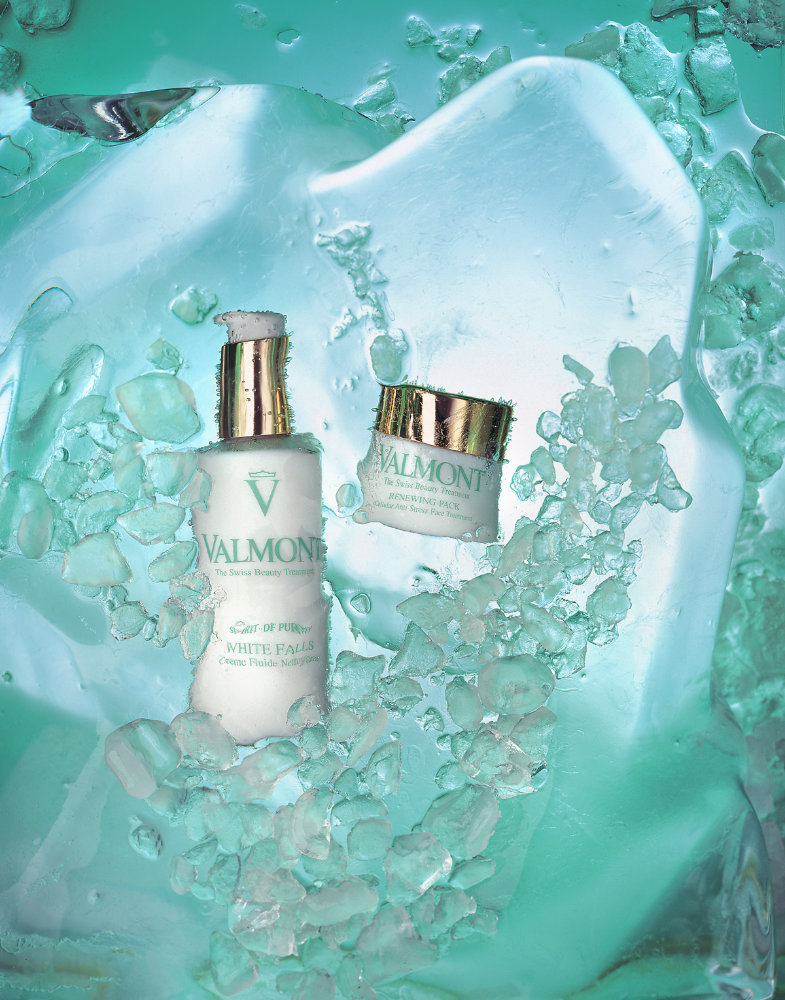 Bottles of cosmetics in glass of water – Photograph by George Ong